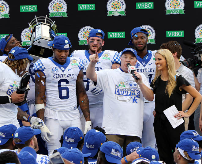 Kentucky head coach Mark Stoops with his star players after the Wildcats' win over Penn State in the Citrus Bowl.