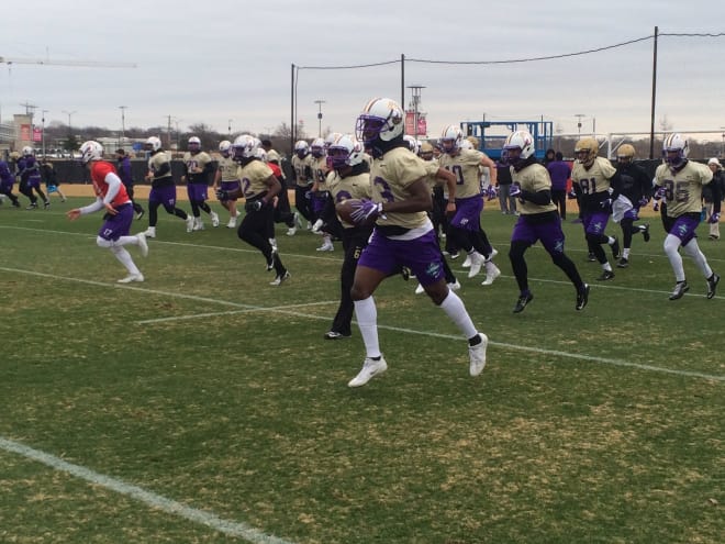 Ishmael Hyman (13) runs through drills with his teammates at James Madison's practice in January in Frisco, Texas.
