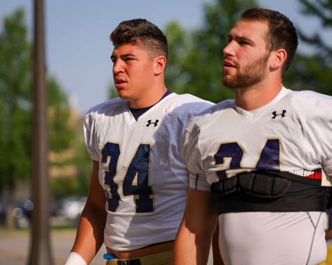 Grad senior linebacker Jack Kiser (24) has taken Notre Dame freshman Drayk Bowen (34) under his wing.