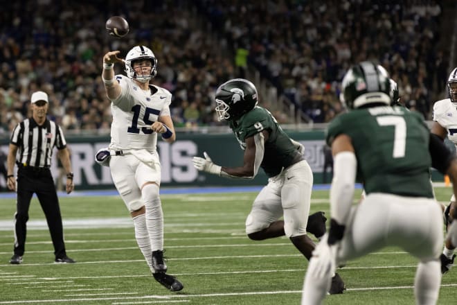 Nov 24, 2023; Detroit, Michigan, USA; Penn State Nittany Lions quarterback Drew Allar (15) passes the ball while pressured by Michigan State Spartans defensive lineman Zion Young (9) during the first half at Ford Field. Mandatory Credit: David Reginek-USA TODAY Sports