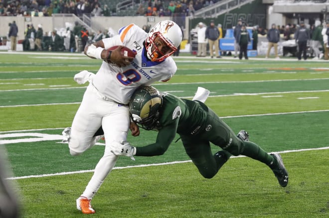 Boise State quarterback Jaylon Henderson, left, runs for a touchdown past Colorado State safety Jamal Hicks in the second half of an NCAA college football game Friday, Nov. 29, 2019, in Fort Collins, Colo. Boise State won 31-24.