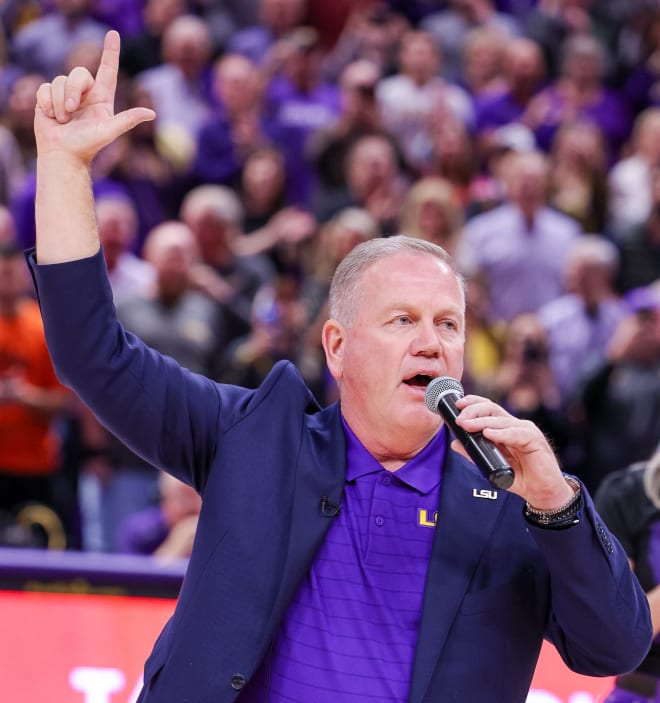 Former Notre Dame head football coach Brian Kelly shows off his new colors at an LSU basketball game on Dec. 1.