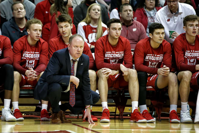 UW head coach Greg Gard watches the action at Indiana with Higginbottom (far left), McGrory (behind Gary) and Ballard (middle) look on.