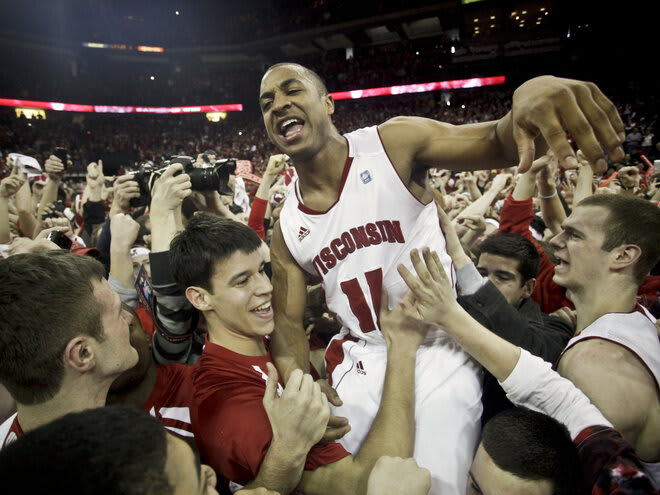 Wisconsin's Jordan Taylor is mobbed by his teammates and fans after scoring 27 points in UW's upset over No.1 Ohio State in 2011.