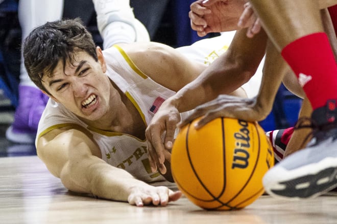 Notre Dame's Cormac Ryan (5) reaches out to try and grab a loose ball during the second half of a 76-62 Irish victory over Louisville, Saturday at Purcell Pavilion.