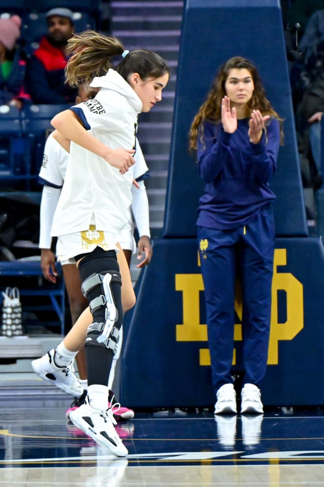 Concussed Notre Dame forward Maddy Westbeld looks on as teammate Sonia Citron warms up before an ACC matchup with North Carolina on Sunday.