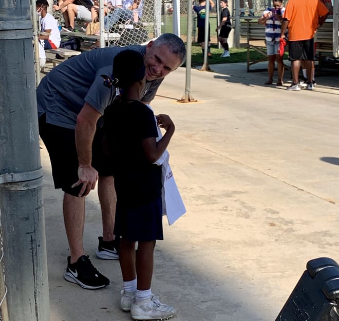 Norvell chats with a young camper before posing for a photo Thursday in Palm Beach County.