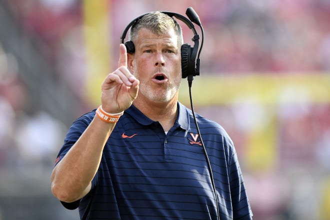 UVa offensive line coach Garett Tujague has made a dozen offers since the school's announcement that he'll remain on staff.