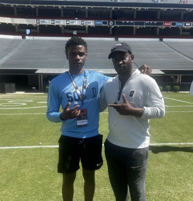 Three-star defensive back Jalon Copeland and Georiga safeties coach Travaris Robinson. Photo via Copeland's Twitter.