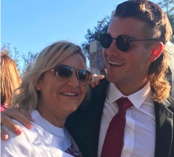 Kathryn Mastromanno hugs her son, Alex, during the FSU Legacy Walk before the UMass game. It was the first time they saw each other in person in 18 months. 