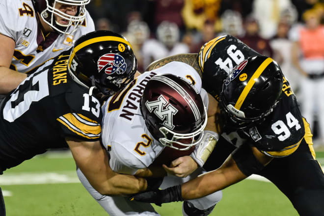 Minnesota Golden Gophers quarterback Tanner Morgan is tackled by Iowa