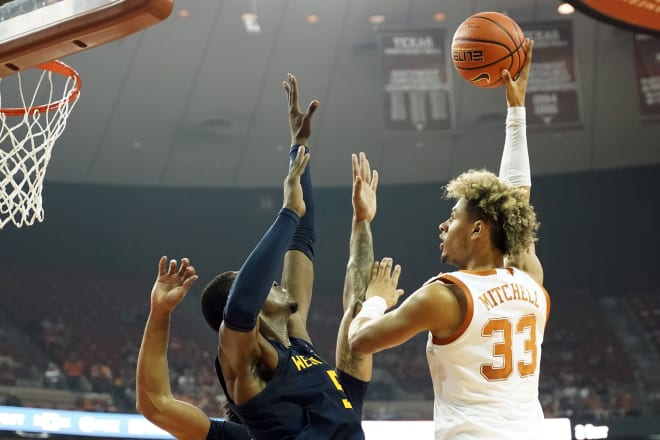 Texas Longhorns forward Tre Mitchell (33) shoots over West Virginia Mountaineers forward Dimon Carrigan (5) during the first half at Frank C. Erwin Jr. Center.