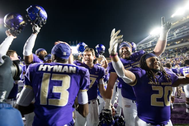 James Madison players celebrate a win this past fall at Bridgeforth Stadium in Harrisonburg.