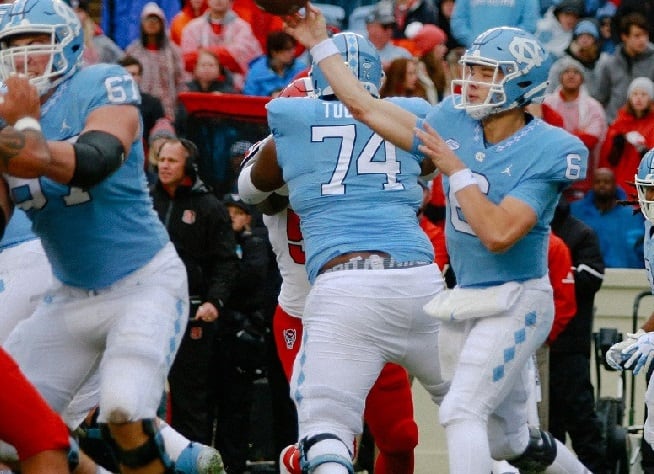 Jordan Tucker (pictured, 74) played just 78 snaps last fall, but he's currently a lock to start at right tackle for the Tar Heels.