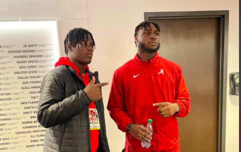 Hunter Osborne (left) with Alabama outside linebacker Will Anderson on Saturday.