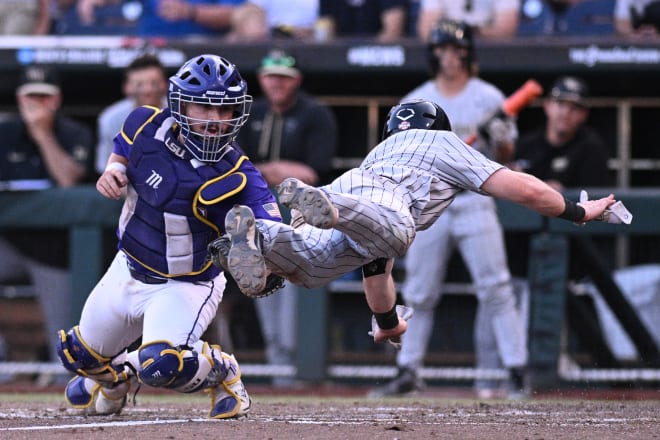 LSU catcher Alex Milazzo (7) tags out Wake Forest second baseman Justin Johnson (6) on a play at the plate in the eighth inning. Johnson tried to score on a one-out bunt by teammate Marek Houston, but LSU first baseman Tre' Morgan scooped the bunt and flipped the ball to Milazzo.