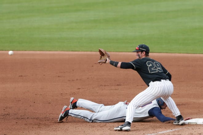 Purdue infielder Cam Thompson (29) waits for the pass as Illinois left fielder Nathan Aide (29) slides back into first during the fourth inning of an NCAA baseball game, Friday, April 23, 2021 at Alexander Field in West Lafayette. Bbc Purdue Vs Illinois