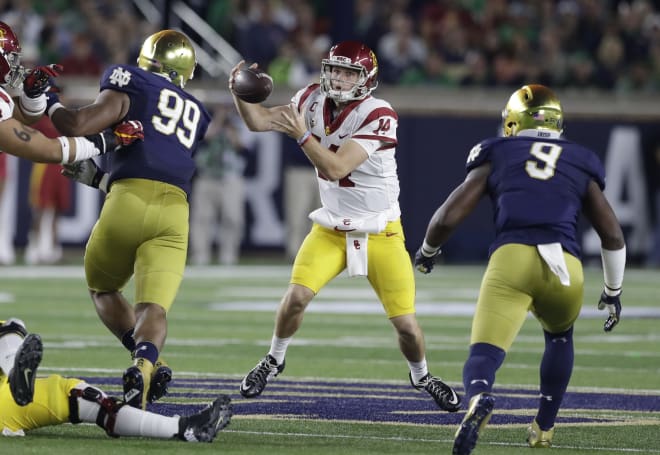 Sam Darnold bobbles a high snap before fumbling against Notre Dame. 