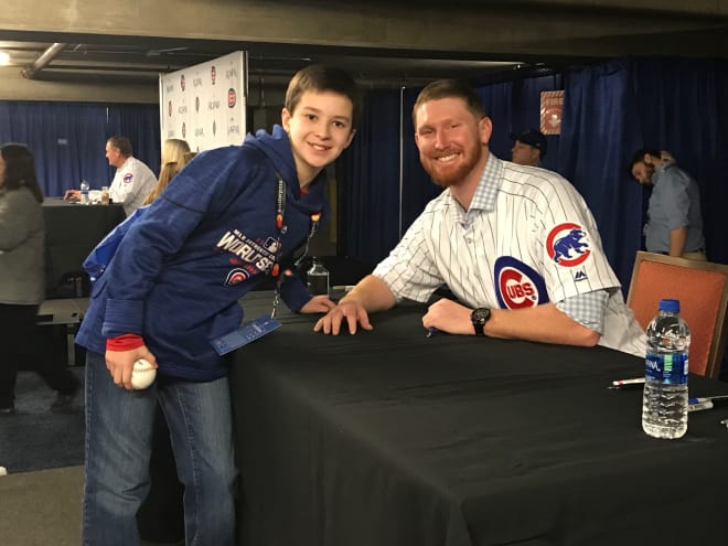 Carson poses with Cubs pitcher Eddie Butler Saturday in Chicago.