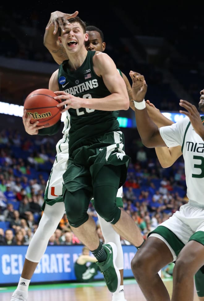Michigan State Spartans guard Matt McQuaid (20) is defended by Miami Hurricanes forward Dewan Huell (20) during the second half in the first round of the 2017 NCAA Tournament at BOK Center.