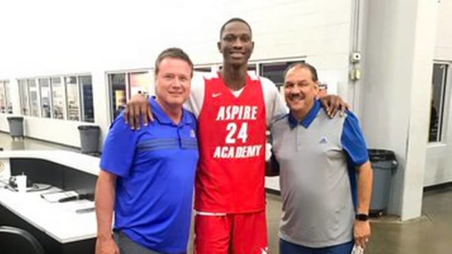 Four-star center Gethro Muscadin with Bill Self and Kurtis Townsend