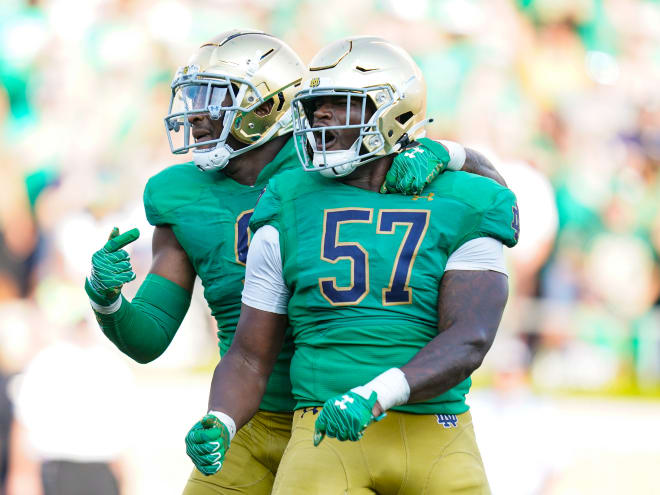 Notre Dame defensive tackle Jayson Ademilola (57) celebrates with his twin brother Justin Ademilola during the Cal game in September.