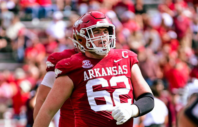 Former Arkansas offensive lineman Brady Latham walks off the field during a 7-3 loss to Mississippi State on Oct. 21. Latham was one of five former Razorbacks invited to the 2024 NFL Draft Combine.