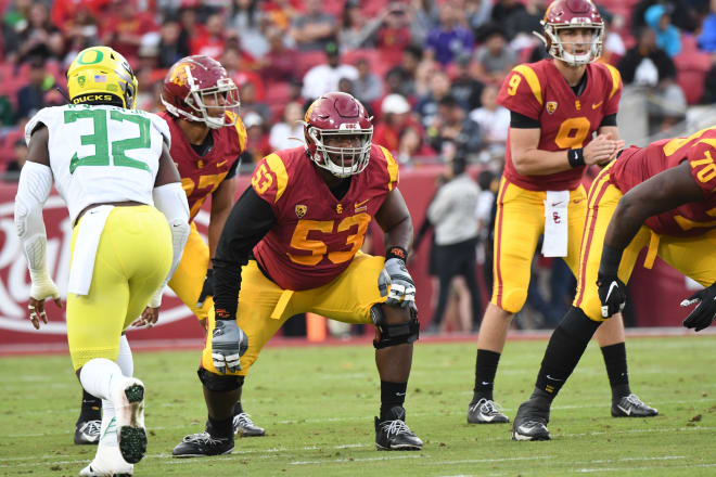 Running back Vavae Malepeai of the USC Trojans pushes through a