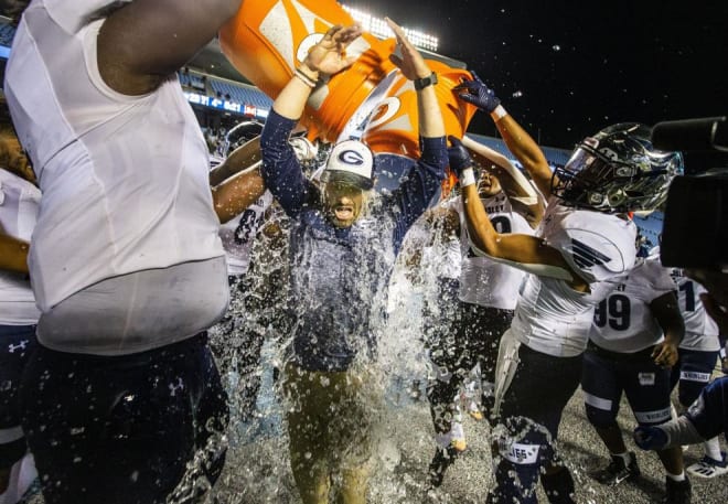 Grimsley players douse head coach Darryl Brown after winning the state title.