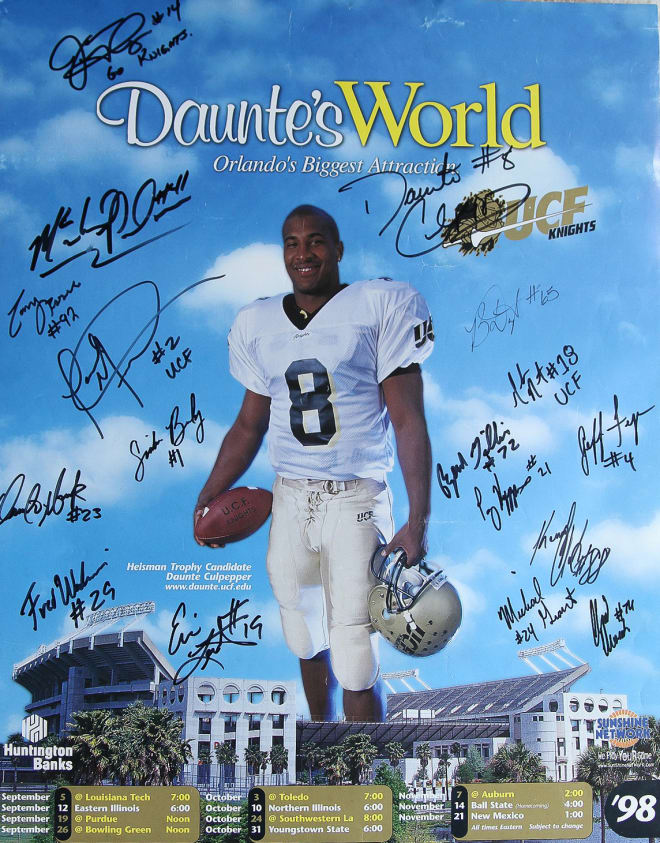 An autographed 1998 schedule poster showcases the "Daunte's World" theme. 