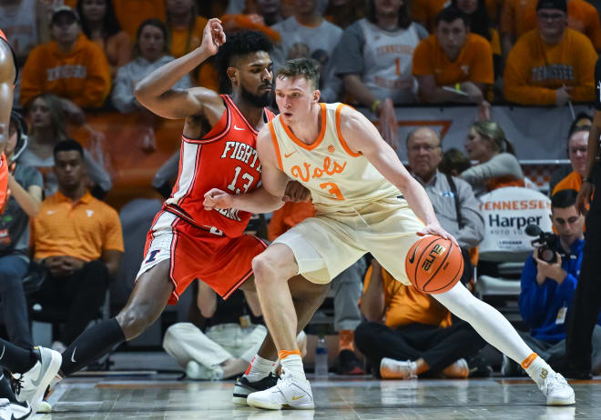  Tennessee Volunteers guard Dalton Knecht (3) controls the ball against Illinois Fighting Illini forward Quincy Guerrier (13) during the college basketball game between the Tennessee Volunteers and the Illinois Fighting Illini on December 9, 2023, at Food City Center in Knoxville, TN