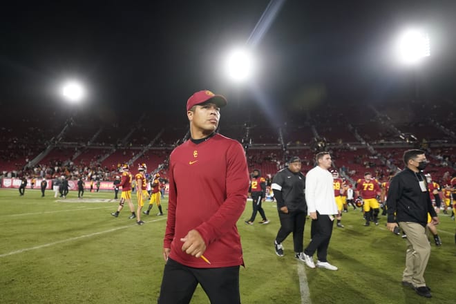USC interim head coach Donte Williams walks off the field after the Trojans' 42-26 loss to Utah on Saturday night in the Coliseum.