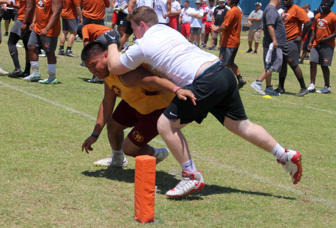 Mountain Pointe defensive lineman Kaleb Whitethorne has his eye on getting to the pylon while being blocked by a Brophy offensive lineman. This was part of the Makoa Big Man Challenge at Chandler HS on Saturday morning.
