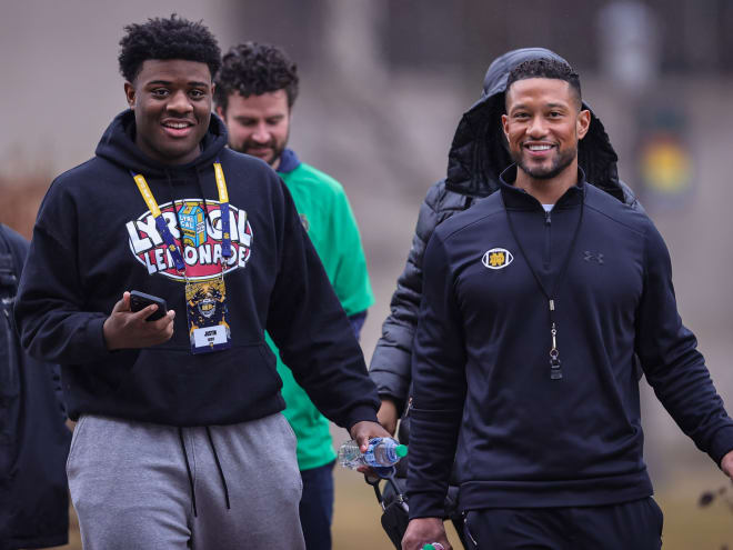 Notre Dame coach Marcus Freeman (right) continues to court five-star DT Justin Scott (left) even after his July 2 commitment to Ohio State.