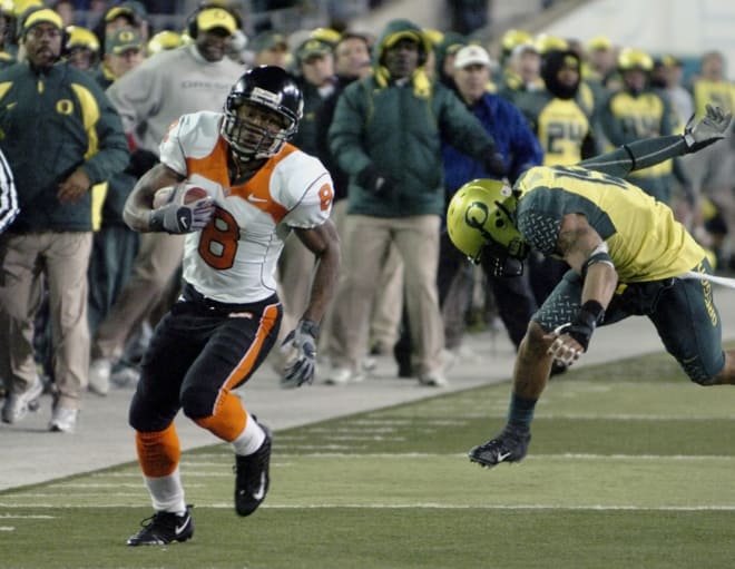 Oregon State's James Rodgers (8) scores the winning touchdown in double overtime of the Civil War football game as Oregon's Patrick Chun (15) chases in Eugene, Ore., Saturday, Dec. 1, 2007. 