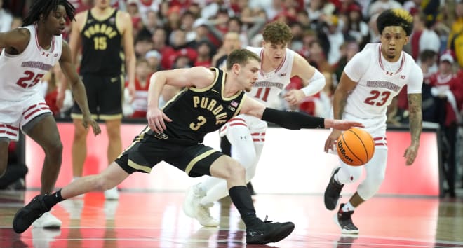 Feb 4, 2024; Madison, Wisconsin, USA; Purdue Boilermakers guard Braden Smith (3) attempts to regain control of the ball as the Wisconsin Badgers defense looks on during the second half at the Kohl Center. Mandatory Credit: Kayla Wolf-USA TODAY Sports