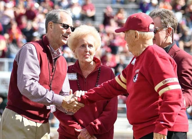 FSU interim athletics director David Coburn greets Al and Judy Dunlap on the field before the Clemson game, when it was announced the Dunlaps would donate $20 million to the athletics department's capital campaign.