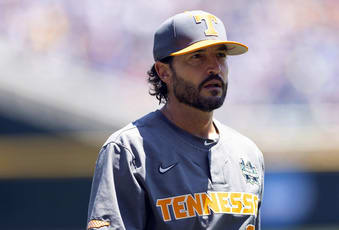 Tennessee head coach Tony Vitello returns to the dugout after meeting with the umpires and Stanford head coach David Esquer before a baseball game at the NCAA College World Series in Omaha, Neb., Monday, June 19, 2023. (AP Photo/Rebecca S. Gratz)