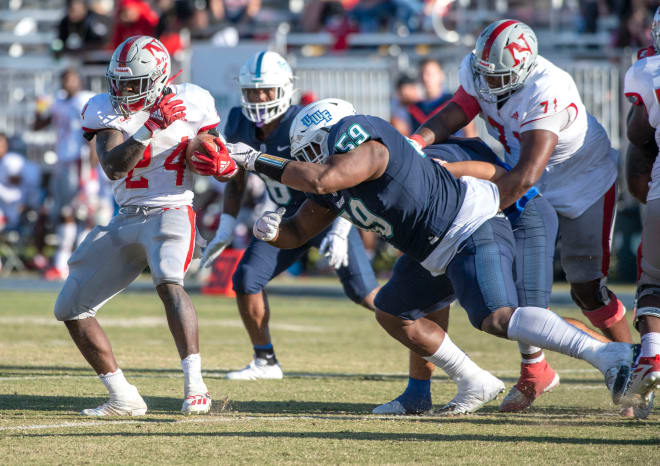 West Florida Argo Myles Meyer (59) brings down Newberry's Mario Anderson (24) during the first round of the NCAA Playoffs against the Newberry Wolves at Blue Wahoos Stadium. Photo | John Blackie/jblackie@pnj.com / USA TODAY NETWORK