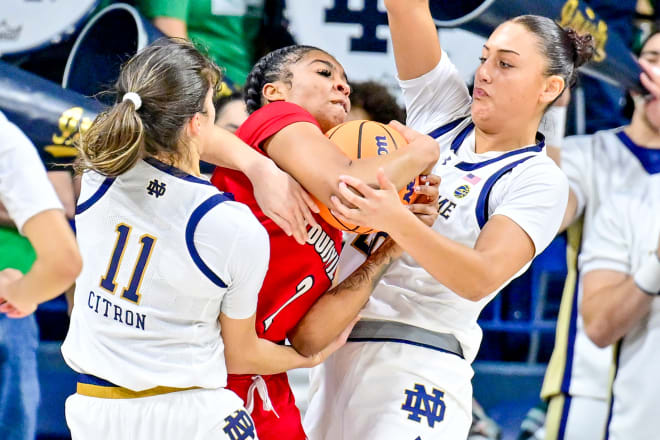 Notre Dame's Kylee Watson and Sonia Citron sandwich Louisville's Nyla Harris during an impressive defensive performance Sunday by the Irish.