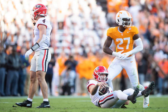 Georgia quarterback Carson Beck (15) is seen on the ground in front of Tennessee defensive lineman James Pearce Jr. (27) during a football game between Tennessee and Georgia at Neyland Stadium in Knoxville, Tenn., on Saturday, Nov. 18, 2023.