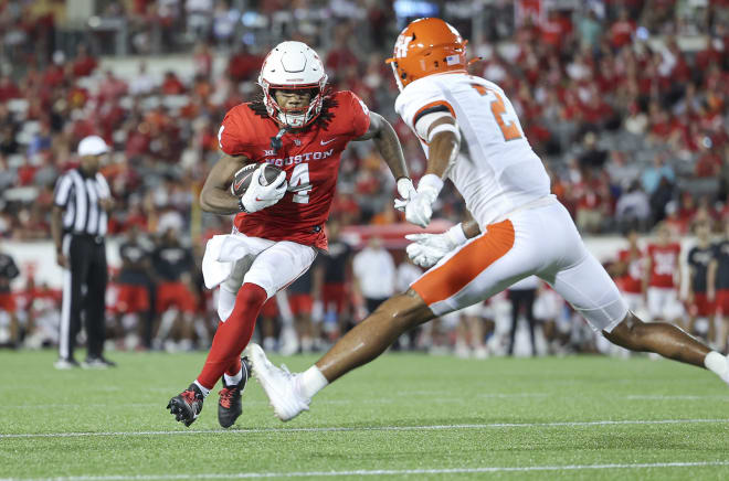 Houston Cougars wide receiver Samuel Brown (4) runs with the ball as Sam Houston State Bearkats defensive back Isaiah Downes (4) defends during the third quarter at TDECU Stadium. Photo | Troy Taormina-USA TODAY Sports