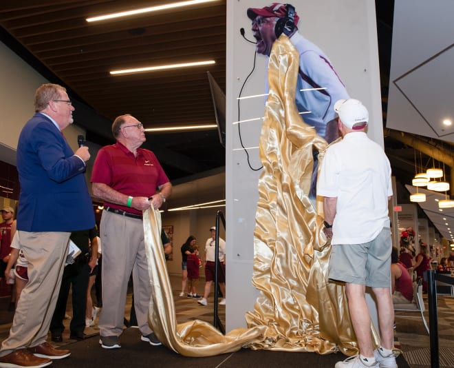 Mickey Andrews watches the unveiling of his column at the Champions Club with Scott Wilson right and Rob Wilson left..