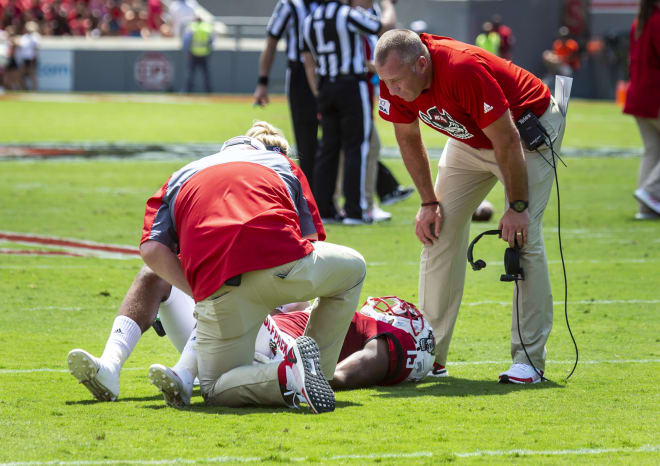 Trainers worked on Riley's injury on the field during Saturday's game.