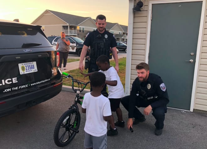 Danny Anthrop and Taylor Turner helped a youngster get a new bike during one stop on their Thursday patrol.