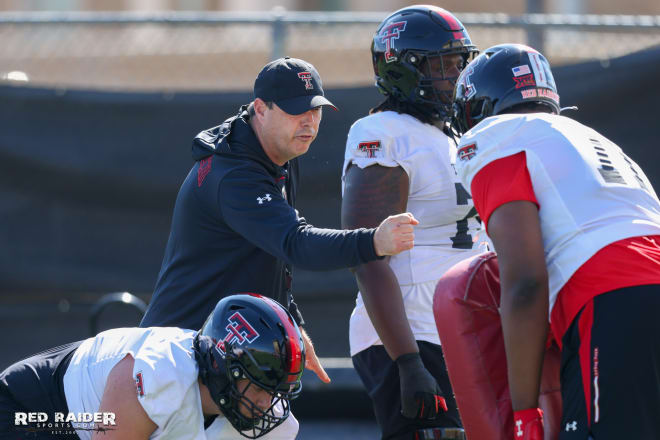 New offensive line coach Clay McGuire working with his group Tuesday