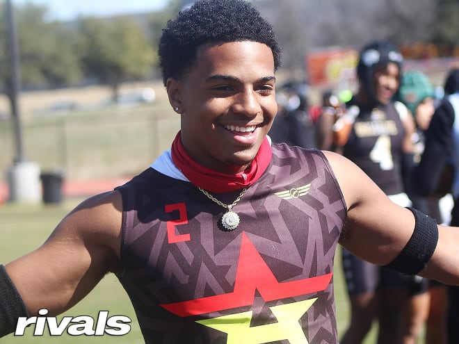 Texas defensive back Braxton Myers holds a Michigan Wolverines football recruiting, Jim Harbaugh offer.