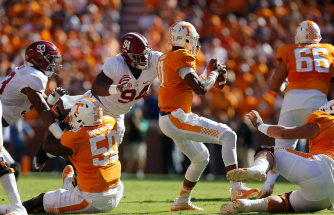 Alabama defensive lineman DaÕRon Payne (94) leaps over a Tennessee lineman to put pressure on Tennessee quarterback Joshua Dobbs (11) Saturday, October 15, 2016 at Neyland Stadium in Knoxville, Tennessee.