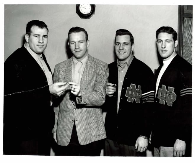 Head coach Terry Brennan (second from left) surrounded by 1954 All-Americans Frank Varrichione (left), Dan Shannon and Ralph Guglielmi, all signed in 1951.