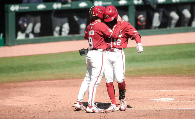 Tavian Josenberger celebrates his home run with John Bolton on Saturday during the Razorbacks' 9-3 win over Auburn.